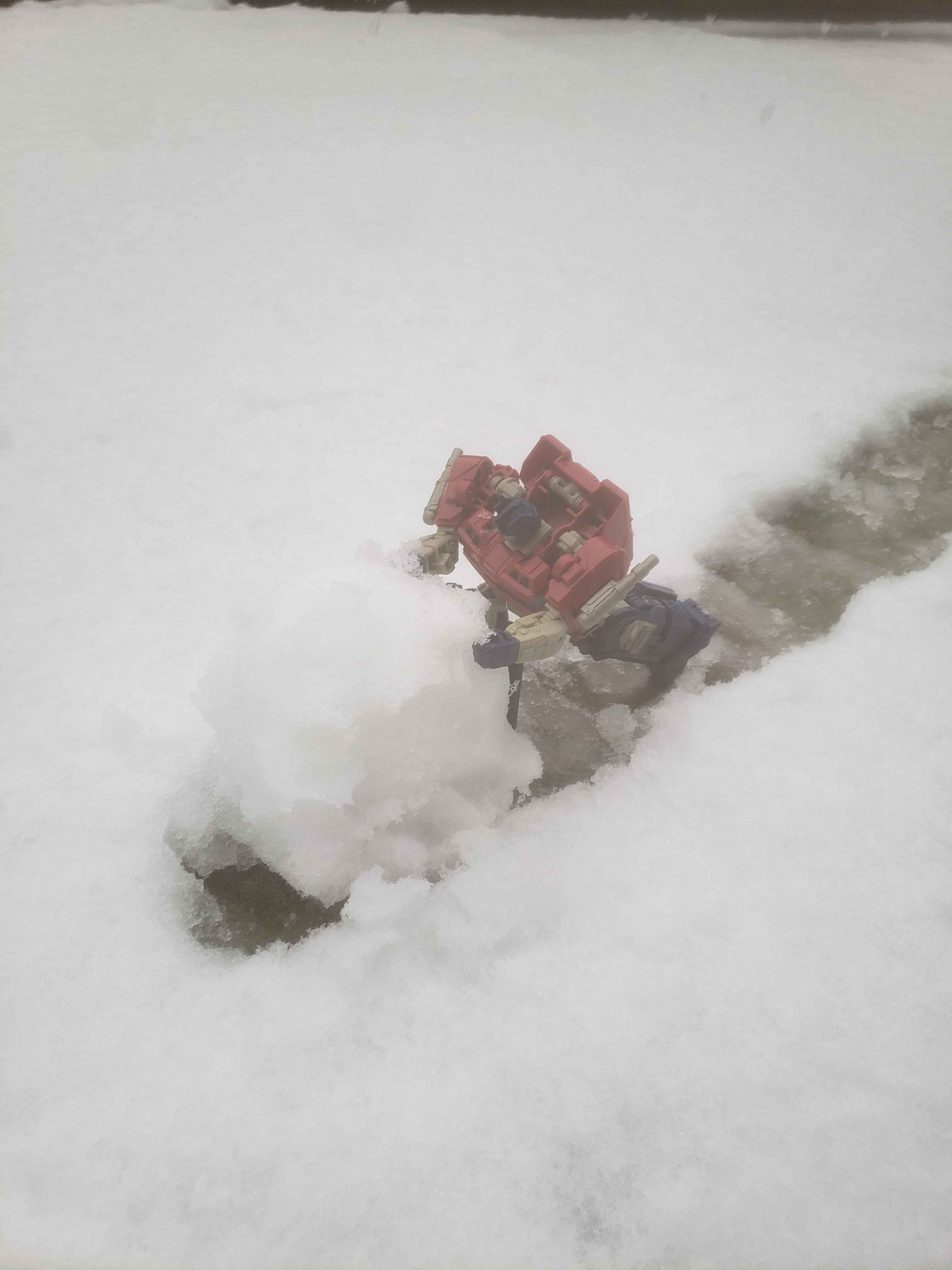 Optimus rolling a snowball.